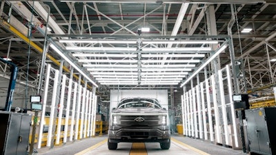 The F-150 Lightning is being produced in the first Ford plant without traditional in-floor conveyor lines, which instead uses robotic Autonomous Guided Vehicles.