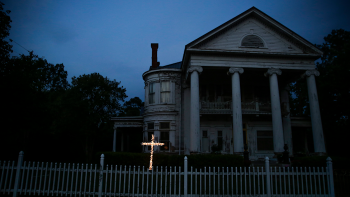 An illuminated cross stands in front of a residence near downtown Dawson, Ga., on April 17, 2020. Both Rocky Ford, Colorado, and Dawson, Georgia, were classified as urban areas after the 2010 census because they had populations over 2,500 residents. Under new criteria posted this spring by the U.S. Census Bureau, these communities would no longer be designated as urban. The new criteria require places to have 2,000 housing units, which is equivalent to 5,000 residents, to be considered an urban area.