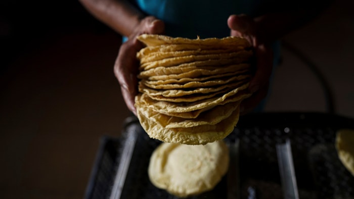 A worker packages tortillas to sell for 20 Mexican Pesos per kilogram — about one dollar — at a tortilla factory in Mexico City, May 9, 2022.