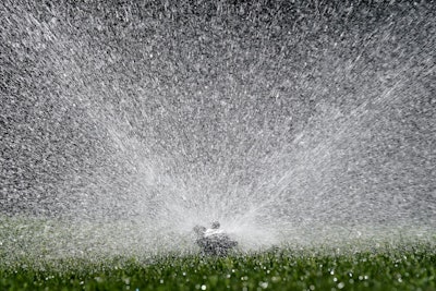 Water flies from a sprinkler watering a lawn, in Sacramento, Calif., Tuesday, May 10, 2022. California's water usage jumped nearly 19% in March during one of the driest months on record, state officials announced, Tuesday, May 10, 2022.