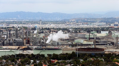 This aerial photo shows the Standard Oil Refinery in El Segundo, Calif., with Los Angeles International Airport in the background and the El Porto neighborhood of Manhattan Beach, Calif., in the foreground on May 25, 2017. A plan released by the California Air Resources Board on Tuesday, May 10, 2022, recommends a majority of the state's oil refineries install carbon capture technology by 2030. Such technology could be used to capture carbon emissions so they don't go out into the atmosphere.