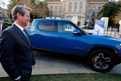 Gov. Brian Kemp stands next to a Rivian electric truck while announcing the company's plans to build a $5 billion plant east of Atlanta projected to employ 7,500 workers, Thursday, Dec. 16, 2021, in Atlanta. Georgia officials could announce a second massive electric vehicle plant to be built by Hyundai near Savannah in coming days.