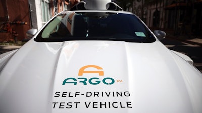 An experimental autonomous vehicle arrives for a drop-off, Dec. 8, 2020, in Miami Beach, Fla. The autonomous vehicle technology company that partners with Ford and Volkswagen says it has started driverless operations in two of eight cities where it is developing its technology. Pittsburgh-based Argo AI has pulled drivers from its autonomous cars in Miami and Austin, though it is still in the testing phase. Its commercial partnerships with Walmart and Lyft still have backup drivers in both cities.