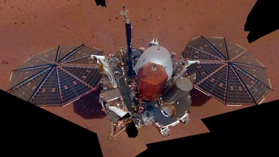 This Dec. 6, 2018 image made available by NASA shows the InSight lander. The scene was assembled from 11 photos taken using its robotic arm. The spacecraft is losing power because of all the dust that's accumulated on its solar panels. NASA said Tuesday, May 17, 2022, it will keep using the spacecraft's seismometer to detect marsquakes until its power peters out. Officials expect operations to cease in July, almost four years after InSight's arrival at Mars.