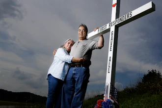 In this Aug. 6, 2019, photo, Ansol and Janie Clark pose at a memorial Ansol Clark constructed near the Kingston Fossil Plant in Kingston, Tenn. The Tennessee Valley Authority was responsible for a massive coal ash spill at the plant in 2008 that covered a community and fouled rivers. The couple says the memorial is for the workers who have come down with illnesses, some fatal, including cancers of the lung, brain, blood and skin and chronic obstructive pulmonary disease. Ansol Clark who drove a fuel truck for four years at the cleanup site, and suffered from a rare blood cancer, has also died now.