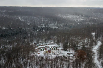This Nov. 13, 2019, aerial photo shows part of an abandoned oil drilling project in the Allegheny National Forest in Pennsylvania. The U.S. Department of the Interior says 20 wells in that forest are among 277 “high priority” polluting orphan wells that will be cleaned up with $33 million from the bipartisan infrastructure act. The wells are on federal land in Pennsylvania, California, Kentucky, Louisiana, Ohio, Oklahoma, Texas, Utah and West Virginia.