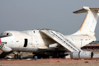 An abandoned plane, Ilyushin Il-76, once tied to arms smuggler Viktor Bout, is being dismantled at the old airfield of Umm al-Quwain, United Arab Emirates, Friday, May 27, 2022. The hulking, Soviet-era cargo plane has sat for decades under the blazing sun in this least-populated corner of the United Arab Emirates, its four jet engines silent after years in the employ of a Russian gunrunner infamously known as the 'Merchant of Death.'