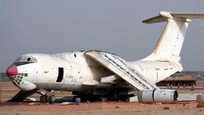 An abandoned plane, Ilyushin Il-76, once tied to arms smuggler Viktor Bout, is being dismantled at the old airfield of Umm al-Quwain, United Arab Emirates, Friday, May 27, 2022. The hulking, Soviet-era cargo plane has sat for decades under the blazing sun in this least-populated corner of the United Arab Emirates, its four jet engines silent after years in the employ of a Russian gunrunner infamously known as the 'Merchant of Death.'