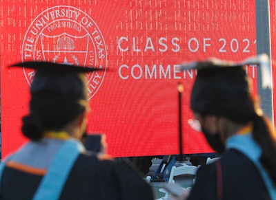 Graduates of the University of Texas Rio Grande Valley attend their commencement ceremony at the schools parking lot on Friday, May 7, 2021, in Edinburg, Texas. Graduate degrees, once touted as the new bachelor’s degrees, are becoming less crucial to get jobs. Today, more college graduates than ever hold advanced degrees, and graduate programs are the only area of higher education that saw enrollment increases during the worst of the pandemic.