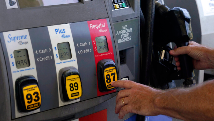 A customer pumps gas at an Exxon gas station, May 10, 2022, Miami.
