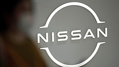 A visitor walks near a Nissan logo at Nissan headquarters on May 12, 2022, in Yokohama near Tokyo. Nissan is considering adding a new auto plant in the U.S. to keep up with growing demand for electric vehicles, a top executive at the Japanese automaker said Friday, May 13, 2022.