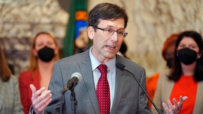 Washington Attorney General Bob Ferguson speaks March 23, 2022, at the Capitol in Olympia, Wash. Months into a complex trial over their role in flooding Washington with highly addictive painkillers, the nation's three largest opioid distributors have agreed to pay the state $518 million. Ferguson announced the deal Tuesday, May 3, 2022.