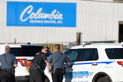 Police stand near where a man opened fire at a business, killing three people before the suspect and a state trooper were wounded in a shootout, according to authorities, in Smithsburg, Md., Thursday, June 9, 2022. The Washington County (Md.) Sheriff's Office said in a news release that three victims were found dead at Columbia Machine Inc. and a fourth victim was critically injured.