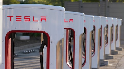 This April 22, 2021, photo shows a Tesla Supercharger station in Buford, Ga. Tesla proposed a three-for-one split of its stock on Friday, June 10, 2022, a move that will make a single share of the electric car maker more accessible to investors but not affect the company's overall market value.