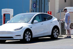 A Tesla owner charges his vehicle at a charging station in Topeka, Kan., Monday, April 5, 2021.