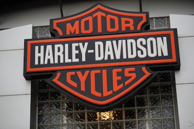 In this Sunday, Oct. 20, 2019 file photo, the company logo hangs over the entrance to a Harley Davidson dealership in Littleton, Colo. Federal regulators have accused Harley-Davidson and Westinghouse of imposing illegal warranty terms on customers and ordered them to fix their warranties and ensure that their dealers compete fairly with independent repair-makers. The Federal Trade Commission announced, Thursday, June 23, 2022, the action against the motorcycle maker and MWE Investments, which makes Westinghouse-brand outdoor power generators and related equipment.