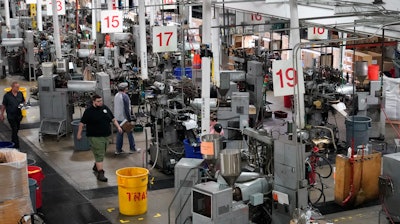 Workers operate record pressing machinery at the United Record Pressing facility Thursday, June 23, 2022, in Nashville, Tenn. The arrival of the compact disc nearly killed off record albums. Four decades later, with resuscitated record album sales producing double-digit growth, manufacturers are rapidly rebuilding an industry to keep pace with sales that topped $1 billion last year.