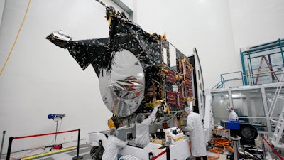 Technicians work on the Psyche spacecraft at the NASA Jet Propulsion Laboratory, April 11, 2022, in Pasadena, Calif. NASA put an asteroid mission on hold Friday, June 24, 2022, blaming the late delivery of its own navigation software. The Psyche mission to a strange metal asteroid of the same name was supposed to launch this September or October. But the agency’s Jet Propulsion Lab was several months late writing and delivering its software for navigation, guidance and control.