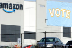 In this March 30, 2021 file photo, a banner encouraging workers to vote in labor balloting is shown at an Amazon warehouse in Bessemer, Ala. Following a string of union victories at Amazon and Starbucks, a group of prominent progressive grantmakers is seeking to put a total of $20 million into a coalition with organized labor that will steer funds to organizing and advocacy campaigns in the South.