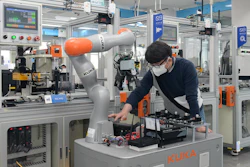 A researcher of the ETRI is controlling a mobile robot by using 5G technology in smart factory.