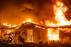 In this Sept. 27, 2020, file photo, a house burns on Platina Road at the Zogg Fire near Ono, Calif. Pacific Gas & Electric on Thursday, June 9, 2022, pleaded not guilty to involuntary manslaughter and other charges it faces after its equipment sparked a Northern California wildfire in 2020 that killed four people and destroyed hundreds of homes.