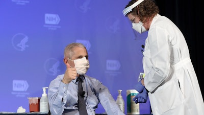 Dr. Anthony Fauci, NIAID Director, gives the thumbs up sign after receiving the Moderna COVID-19 vaccine at the HHS/NIH COVID-19 Vaccine Kick-Off event at NIH on 12/22/20.