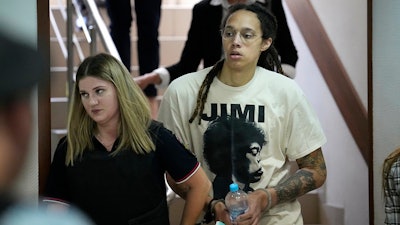 WNBA star and two-time Olympic gold medalist Brittney Griner is escorted to a courtroom for a hearing, in Khimki just outside Moscow, Russia, Friday, July 1, 2022.