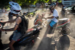 People gather on their electric scooters to spend the late afternoon showing off stunts and racing in Havana, Cuba, Friday, July 15, 2022.
