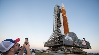 Invited guests and NASA employees take photos as NASA's Space Launch System (SLS) rocket with the Orion spacecraft aboard is rolled out of High Bay 3 of the Vehicle Assembly Building for the first time, at the Kennedy Space Center in Cape Canaveral, Fla., Thursday, March 17, 2022. On Wednesday, July 20, 2022, the 53rd anniversary of the Apollo 11 moon landing, NASA said it’s shooting for a late August test launch of its giant, new moon rocket.