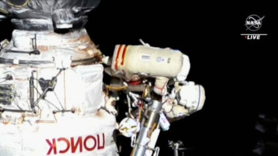 This image provided by NASA, Italian astronaut Samantha Cristoforetti and Russian cosmonaut Oleg Artemyev perform maintenance on the International Space Station on Thursday, July 21, 2022. Cristoforetti teamed up with Artemyev to work on the International Space Station’s newest robot arm. The 37-foot (11-meter) mechanical limb _ contributed by the European Space Agency _ rocketed into orbit with a Russian lab last July.