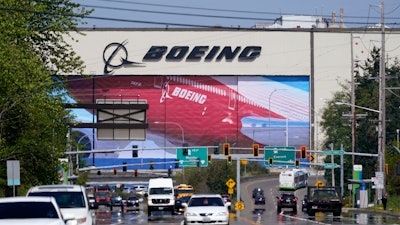 Traffic drives in view of a Boeing Co. production plant, where images of jets decorate the hangar doors on April 23, 2021, in Everett, Wash. Roughly 2,500 Boeing workers are expected to go on strike the following month at three plants in the St. Louis area after they voted Sunday, July 24, 2022, to reject a contract offer from the plane maker.