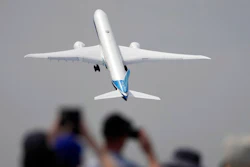 A Boing 777X plane takes off at the Farnborough Air Show fair in Farnborough, England, Monday, July 18, 2022. Some 1200 exhibitors from around the world will show their newest developments in Future Flight, Space, Defence, Innovation, Sustainability and Workforce from July 18 until July 22, 2022.