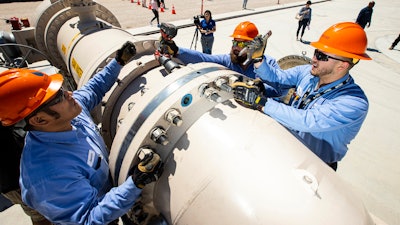 Southern Nevada Water Authority maintenance mechanics, from left, Jason Dondoy, Patrick Smith and Tony Mercado install a spacer flange after removing an energy dissipator at the Low Lake Level Pumping Station (L3P3) at Lake Mead National Recreation Area on April 27, 2022, outside of Las Vegas.