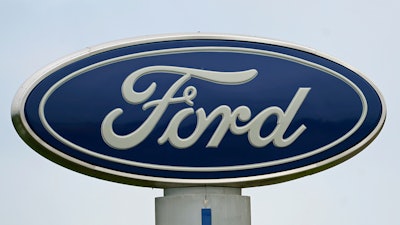 A Ford logo is seen on signage at Country Ford in Graham, N.C., Tuesday, July 27, 2021. Ford Motor Co. is cutting about 3,000 white-collar workers as it moves reduce costs and make the transition from internal combustion to electric vehicles, leaders of the Dearborn, Mich., automaker announced Monday, Aug. 22, 2022, in a companywide email.