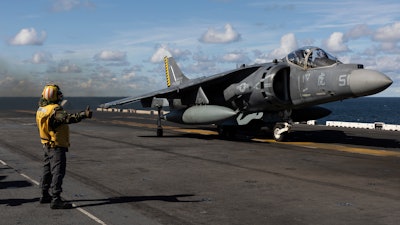 Final checker gives a thumb up to a AV-8B Harrier taking off from the flight deck of the Wasp-class amphibious assault ship USS Kearsarge (LHD 3), operating in the Baltic Sea, Saturday, Sept. 3, 2022.