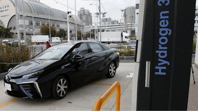 A Toyota Motor Corp.'s new hydrogen fuel cell vehicle Mirai arrives at a charge station near Toyota's showroom on Nov. 17, 2014, in Tokyo.
