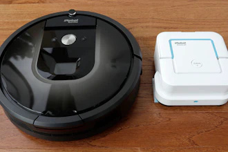 In this Thursday, Aug. 25, 2016, photo, an iRobot Roomba vacuum, left, and Braava Jet floor cleaner are displayed at the company's headquarters in Bedford, Mass.