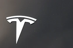 The Tesla company logo is seen on the hood of an unsold vehicle at a dealership, Sunday, Aug. 9, 2020, in Littleton, Colo. Tesla is recalling nearly 1.1 million vehicles in the U.S. because the windows can pinch a person’s fingers when being rolled up.