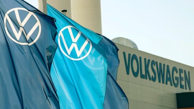 Company logo flags wave in front of a Volkswagen factory building in Zwickau, Germany, on April 23, 2020. Volkswagen was nearing the finish line Wednesday, Sept. 28, 2022, as it readied the sale of shares in luxury carmaker Porsche ahead of an expected market listing that will rank among the largest such offerings in European history.