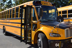 An electric school bus, leased by Beverly Public Schools in Beverly, Mass., rests in a bus yard, Oct. 21, 2021, in Beverly, Mass.