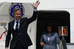 US Secretary of State Antony Blinken waves in front of US Commerce Secretary Gina Raimondo as they deplane at Benito Juarez International Airport in Mexico City.
