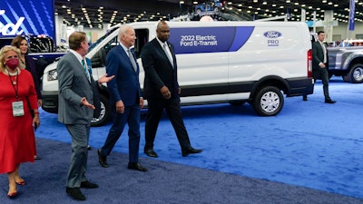 President Joe Biden listens during a tour at the Detroit Auto Show, Sept. 14, 2022, in Detroit. From left, Rep. Debbie Dingell, D-Mich., Michigan Gov. Gretchen Whitmer, Bill Ford, executive chairman of Ford Motor Company, Biden and Ray Curry, President of the United Auto Workers.