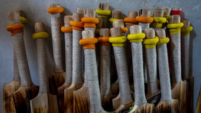 Finished cricket bats are seen inside a factory in Sangam, south of Srinagar, Indian controlled Kashmir, Sept. 22, 2022.