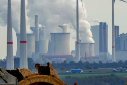 Steam comes out of the chimneys of the coal-fired power station Neurath near the RWE Garzweiler open-cast coal mine in Luetzerath, Germany, Monday, Oct.25, 2021.