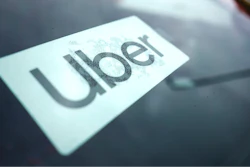 An Uber sign is displayed inside a car in Palatine, Ill., Thursday, Feb. 10, 2022.