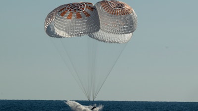 In this photo provided by NASA, the SpaceX Crew Dragon Freedom capsule splashes down in the Atlantic Ocean off Florida in a return trip from the International Space Station on Friday, Oct. 14, 2022.
