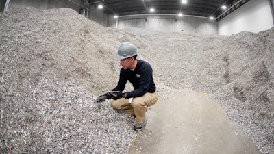 Jeremy DeBenedictis, President of Alterra Energy, stands in the storage area of shredded plastics his company receives from recycling facilities in their facility in Akron, Ohio, on Thursday, Sept. 8, 2022. “Our mission is to solve plastic pollution,” said DeBenedictis, company president. “That is not just a tag line. We all truly want to solve plastic pollution.”
