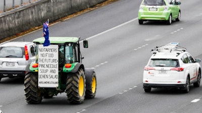 A tractor drives down the southern motorway in central Auckland, Oct. 20, 2022.