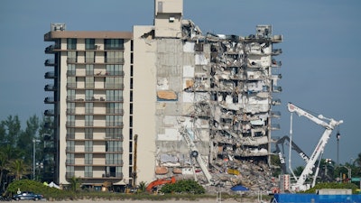 Coast Guard boats patrol in front of the partially collapsed Champlain Towers South condo building in Surfside, Fla on July 1, 2021.