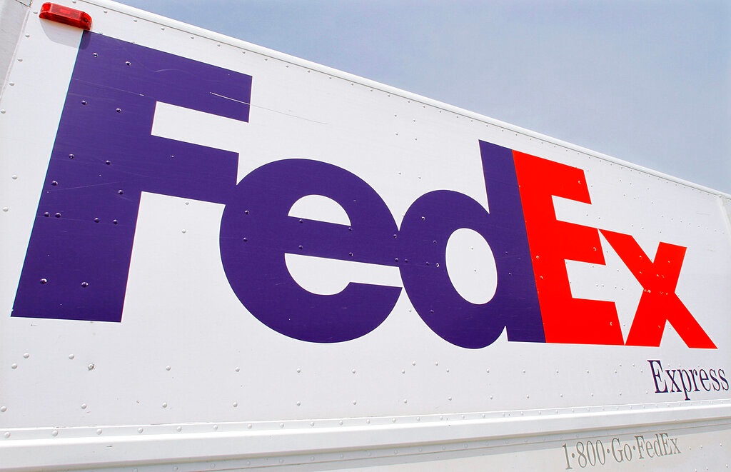 The FedEx logo is seen on a delivery truck, Tuesday, June 21, 2011, in Springfield, Ill. On Monday, Oct. 17, 2022, a federal judge dismissed FedEx from a lawsuit filed by relatives of five of the eight people who were fatally shot last year at an Indianapolis warehouse by a former employee of the shipping giant.